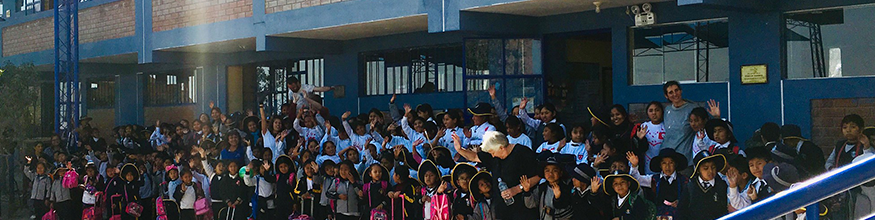Group shot of school children waving